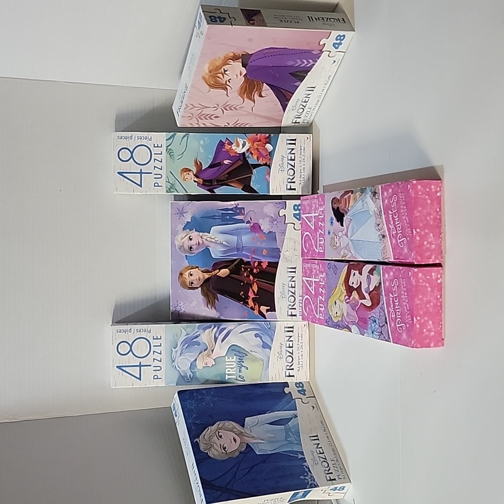 Disney Frozen puzzles 5, plus 2 Disney Princess puzzles.